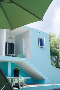 Hill View Studio building with stairs and a green umbrella