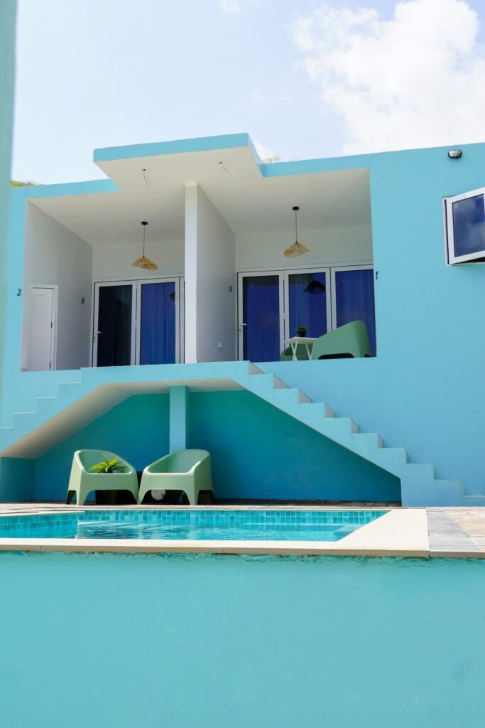 Turquoise studio building above the shared pool