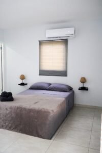Ocean View Studio bedroom with a double bed and air conditioning