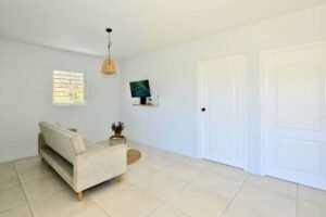 Villa living room with a sofa and wall-mounted TV