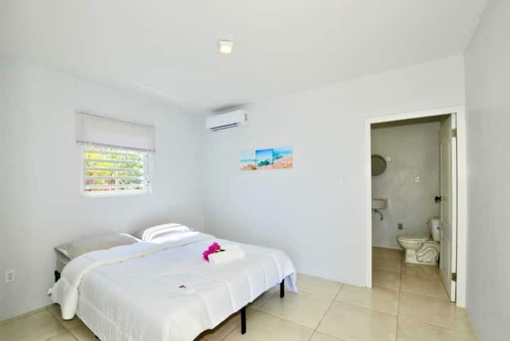 Villa bedroom with a double bed and en-suite bathroom