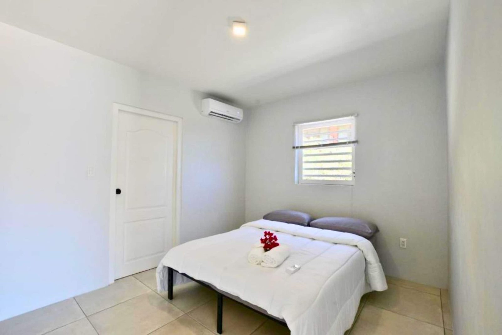 Second villa bedroom with a double bed and air conditioning