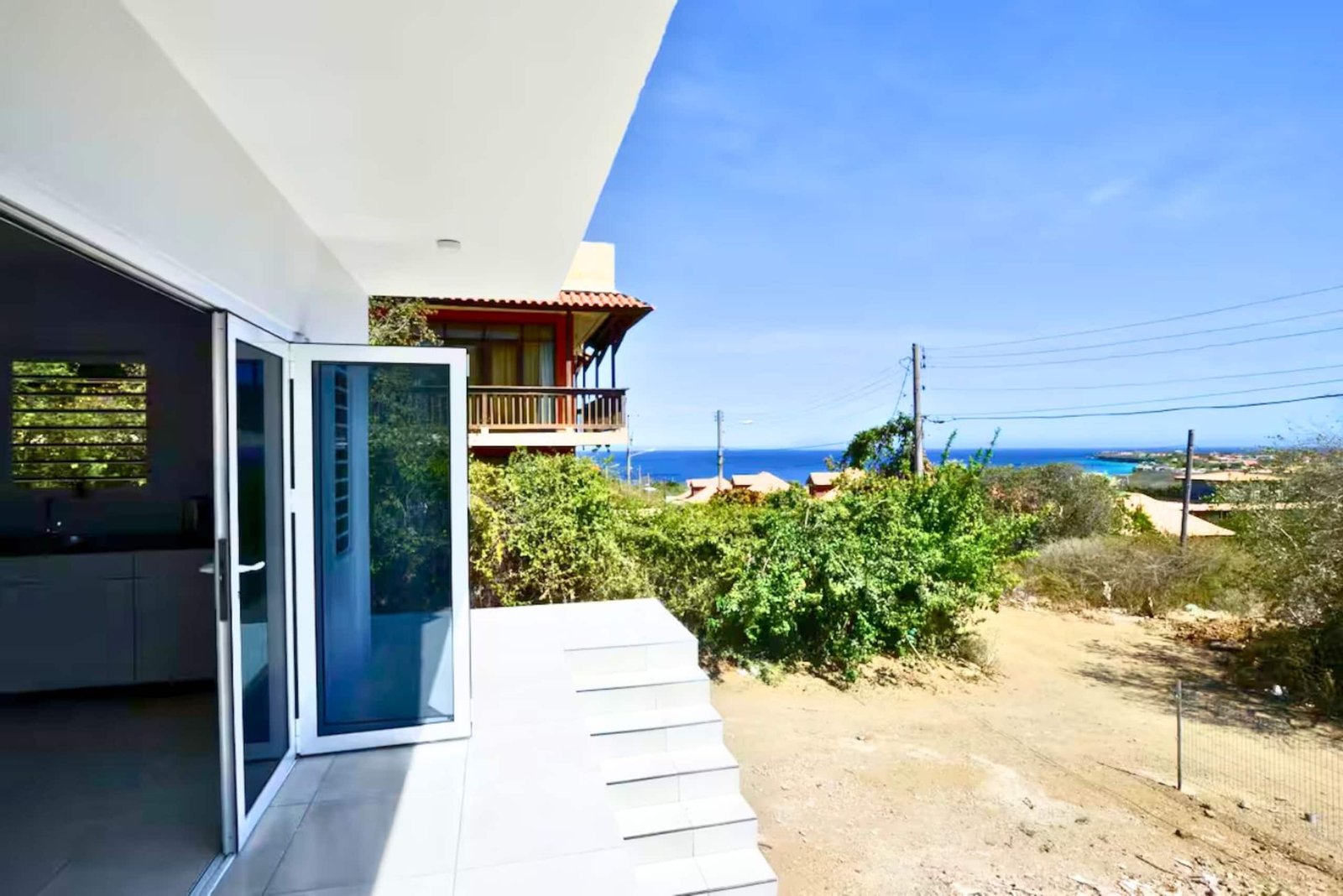 Villa terrace doors opening to a sea view